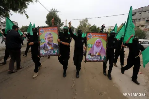 Members of Hamas movement hold the movement's flag as they take part in a rally ahead of the 27th anniversary of Hamas founding, in Shijaiyah in the east of Gaza city December 12, 2014. Photo by Mohammed Asad