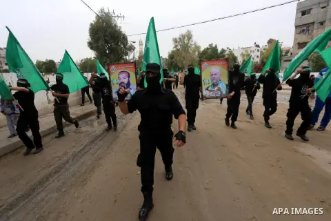 Members of Hamas movement hold the movement's flag as they take part in a rally ahead of the 27th anniversary of Hamas founding, in Shijaiyah in the east of Gaza city December 12, 2014. Photo by Mohammed Asad