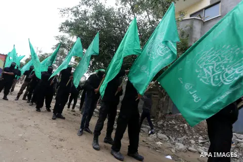 Members of Hamas movement hold the movement's flag as they take part in a rally ahead of the 27th anniversary of Hamas founding, in Shijaiyah in the east of Gaza city December 12, 2014. Photo by Mohammed Asad