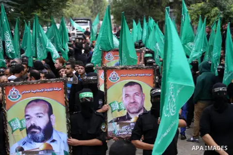 Members of Hamas movement hold the movement's flag as they take part in a rally ahead of the 27th anniversary of Hamas founding, in Shijaiyah in the east of Gaza city December 12, 2014. Photo by Mohammed Asad