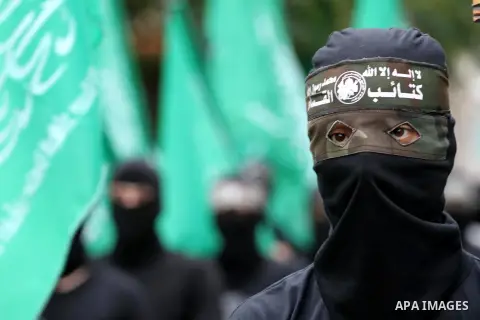 Members of Hamas movement hold the movement's flag as they take part in a rally ahead of the 27th anniversary of Hamas founding, in Shijaiyah in the east of Gaza city December 12, 2014. Photo by Mohammed Asad