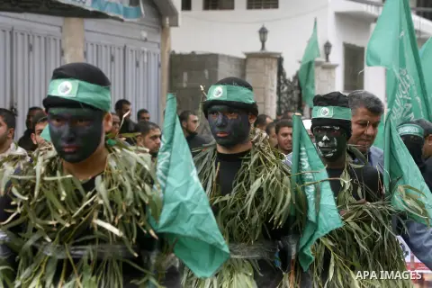 Palestinian militants from the Ezzedine al-Qassam brigade take part during a rally to commemorate the 27th anniversary of the Islamist movement s creation, at the Nuseirat refugee camp in the Central Gaza Strip on Decemb...