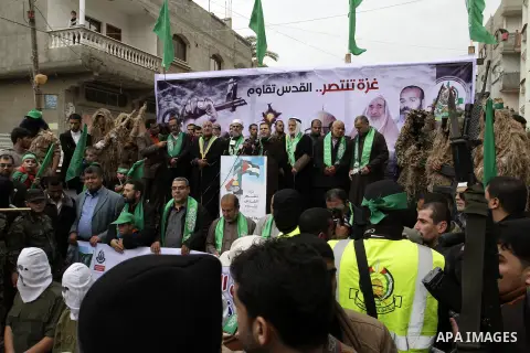 Supporters of Hamas take part during a rally to commemorate the 27th anniversary of the Islamist movement s creation, at the Nuseirat refugee camp in the Central Gaza Strip on December 12, 2014. Photo by Abed Rahim Khati...