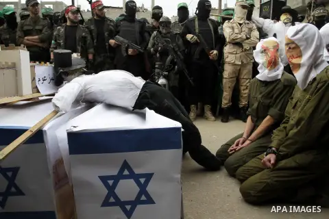 Palestinian militants from the Ezzedine al-Qassam brigade take part during a rally to commemorate the 27th anniversary of the Islamist movement s creation, at the Nuseirat refugee camp in the Central Gaza Strip on Decemb...