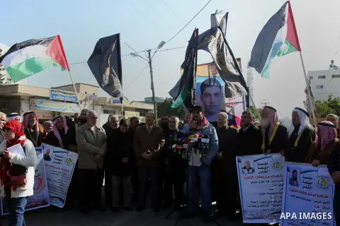 Palestinians hold banners during a protest demanding the release of their relatives prisoners held in Israeli jails in Gaza City on December 13, 2014. Photo by Yasser Qudih