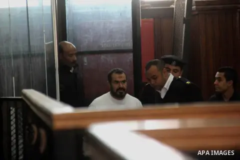 A member of Muslim Brotherhood attends his trial at the court Cairo on December 13, 2014. Resumption of trial of Muslim Brotherhood Supreme Guide Mohamed Badie and 50 others in the case of the Rabaa operating room. Photo...