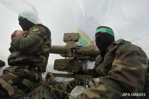 Palestinian members of the marine unit of al-Qassam Brigades, the armed wing of the Hamas movement, ride in a pickup truck as they take part in a military parade marking the 27th anniversary of Hamas' founding, in Gaza C...