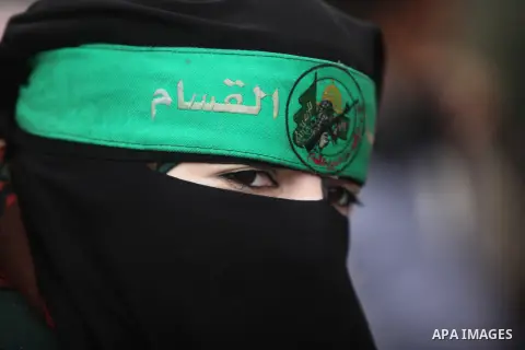 A Palestinian woman attends a military parade marking the 27th anniversary of Hamas' founding, in Gaza City December 14, 2014. Photo by Ashraf Amra