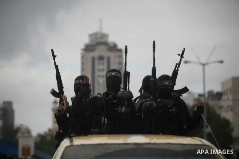Palestinian members of the marine unit of al-Qassam Brigades, the armed wing of the Hamas movement, ride in a pickup truck as they take part in a military parade marking the 27th anniversary of Hamas' founding, in Gaza C...