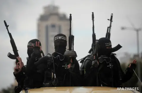 Palestinian members of the marine unit of al-Qassam Brigades, the armed wing of the Hamas movement, ride in a pickup truck as they take part in a military parade marking the 27th anniversary of Hamas' founding, in Gaza C...