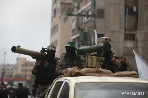 Palestinian members of the marine unit of al-Qassam Brigades, the armed wing of the Hamas movement, ride in a pickup truck as they take part in a military parade marking the 27th anniversary of Hamas' founding, in Gaza C...