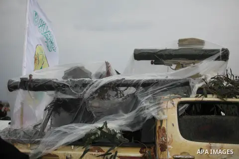 Palestinian members of al-Qassam Brigades, the armed wing of the Hamas movement, display a home-made Qassam rocket during a military parade marking the 27th anniversary of Hamas' founding, in Gaza City December 14, 2014....