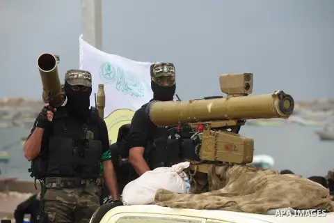 Palestinian members of al-Qassam Brigades, the armed wing of the Hamas movement, display a home-made Qassam rocket during a military parade marking the 27th anniversary of Hamas' founding, in Gaza City December 14, 2014....