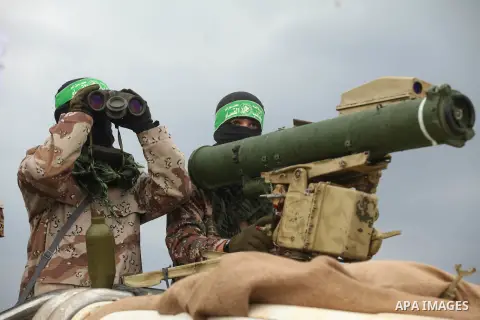 Palestinian members of al-Qassam Brigades, the armed wing of the Hamas movement, display a home-made Qassam rocket during a military parade marking the 27th anniversary of Hamas' founding, in Gaza City December 14, 2014....