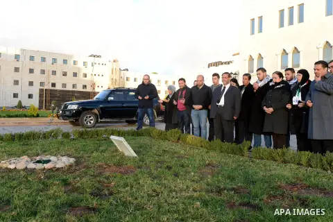 Members of the family of late Palestinian Cabinet member Ziad Abu Ain, visit the last olive tree sapling that he was planted before his death, after it was transferred to al-Moqata'a, the headquarter of Palestinian Presi...