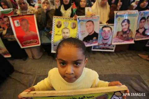 Palestinians take part a protest demanding the release of their relatives prisoners held in Israeli jails, in front of the Red Cross office in Gaza City, on Dec. 15, 2014. Photo by Ashraf Amra