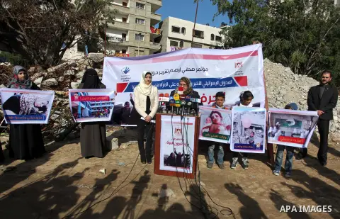Palestinian minister of women affairs Haifaa al-Agha, speaks during a media conference in front of the Italian Complex, which was destroyed by Israeli air strike during the Israel-Gaza conflict, in Gaza city on December...