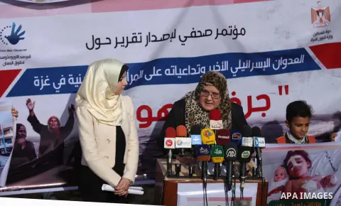 Palestinian minister of women affairs Haifaa al-Agha, speaks during a media conference in front of the Italian Complex, which was destroyed by Israeli air strike during the Israel-Gaza conflict, in Gaza city on December...