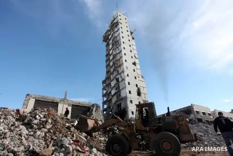 Palestinian workers remove the rubbles from the Italian Complex, which was destroyed by Israeli air strike during the Israel-Gaza conflict, in Gaza city on December 17, 2014. Photo by Ashraf Amra