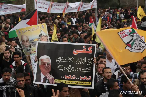 Palestinian supporters of former leader of Fatah in Gaza, Mohammed Dahlan, hold posters depicting Dahlan during a protest against Palestinian President Mahmoud Abbas in Gaza City December 18, 2014. Dahlan, who lives in e...