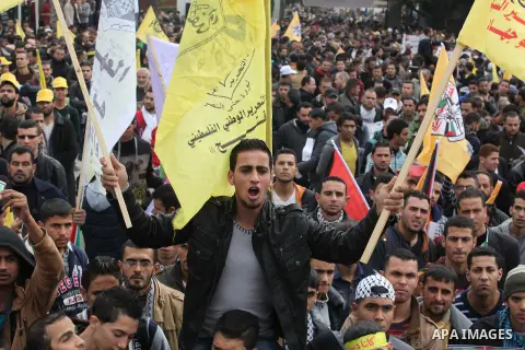 Palestinian supporters of former leader of Fatah in Gaza, Mohammed Dahlan, hold posters depicting Dahlan during a protest against Palestinian President Mahmoud Abbas in Gaza City December 18, 2014. Dahlan, who lives in e...
