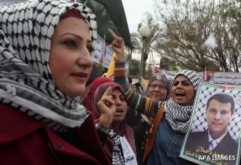 Palestinian supporters of former leader of Fatah in Gaza, Mohammed Dahlan, hold posters depicting Dahlan during a protest against Palestinian President Mahmoud Abbas in Gaza City December 18, 2014. Dahlan, who lives in e...