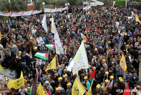 Palestinian supporters of former leader of Fatah in Gaza, Mohammed Dahlan, hold posters depicting Dahlan during a protest against Palestinian President Mahmoud Abbas in Gaza City December 18, 2014. Dahlan, who lives in e...