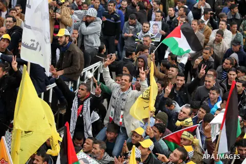 Palestinian supporters of former leader of Fatah in Gaza, Mohammed Dahlan, hold posters depicting Dahlan during a protest against Palestinian President Mahmoud Abbas in Gaza City December 18, 2014. Dahlan, who lives in e...