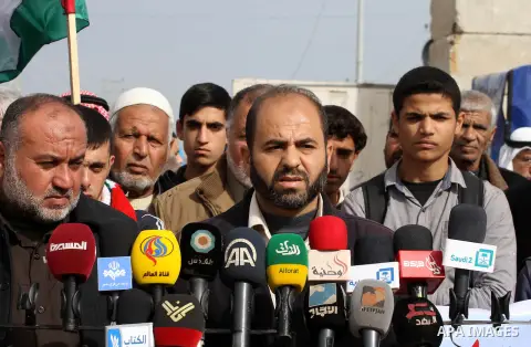 Palestinians gather during a protest against the delay in acquiring building material in front of Eriz crossing border, in the norhtern Gaza Strip on December 18, 2014. According to housing minister Mufeed al-Hasayna, Ga...
