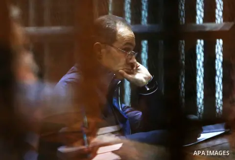 Gamal Mubarak, the son of former president Hosni Mubarak sits in a courtroom cage in Cairo, December 18, 2014. The two sons of Egypt's former president were back in court facing charges of stock market manipulation. Phot...