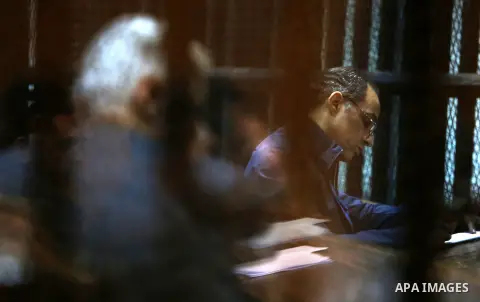 Gamal Mubarak, the son of former president Hosni Mubarak sits in a courtroom cage in Cairo, December 18, 2014. The two sons of Egypt's former president were back in court facing charges of stock market manipulation. Phot...