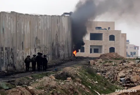 Members of Israeli security forces take position during clashes following a demonstration against Israeli settlements at Qalandiya checkpoint near the West Bank City of Ramallah on December 19, 2014. A Palestinian senior...