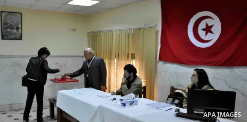 A Tunisian woman living in Egypt casts her ballot in Cairo, Egypt, Dec. 19, 2014. Overseas Tunisians started voting on Friday as Tunisia's second round of presidential election will be held in Tunisia on Dec. 21, 2014. P...