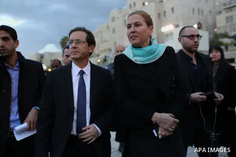 Former Israeli justice minister and head of the Hatnuah party, Tzipi Livni and Labor Party chairman Isaac Herzog arrive to light the sixth candle of Hanukkah menorah at the Western Wall at the Old City of Jerusalem, 21 D...