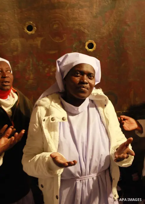 Nigerian pilgrims arrive to pray as part of Christmas celebrations inside the Grotto at the Church of the Nativity, believed to be the birthplace of Jesus Christ, on December 24, 2014 in the West Bank biblical town of Be...