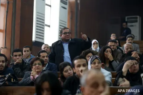 Relatives and friends attend the retrial of Alaa Abdel Fattah and 24 others, in a court in Cairo on December 27, 2014. The defendants were sentenced in June to 15 years in prison for holding an unlicensed and violent pro...