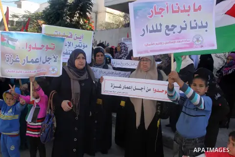 Palestinians take part in a protest calling for end the Israeli illegal blockade on Gaza Strip and against the slow rehabilitation of the strip after damage incurred during the recent Israeli offensive on Gaza Strip, in...