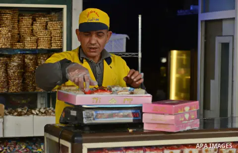 An Egyptian man sells sweets in preparation to celebrate the birthday of prophet Muhammad, also known as "Mawlid Nabawi", which will fall next week, in Cairo, December 31, 2014. Photo by Amr Sayed