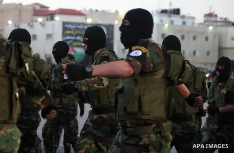 Palestinian Fatah movement fighters parade during a rally marking the 50th anniversary of the founding of the Fatah movement, in the West Bank city of Ramallah December 31, 2014. Abbas signed on to 20 international agree...