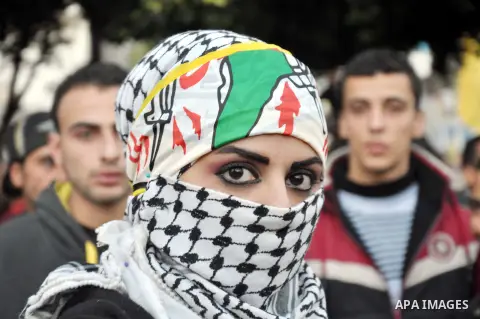 Palestinian Fatah supporter shout slogans during a gathering to celebrate the fiftieth anniversary of the start of the Fatah movement, in Gaza city on December 31, 2014. The Fatah movement was founded by the late iconic...
