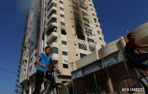 Palestinians inspect the remains of a building following an Israeli airstrike, in Gaza city, on November 12, 2019. Photo by Ashraf Amra