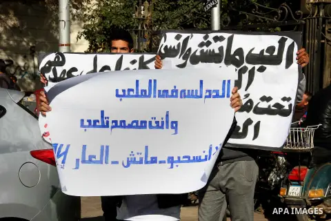 Egyptians families hold banners and pictures for their sons who killed in stadium riot in the canal city of Port Said, during a protest in front of headquarter of Al-ahly club in Cairo, Egypt, on January 06, 2015. Photo...