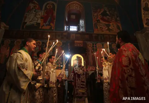 Palestinian Orthodox clergymen lead a Christmas mass at the Saint Porphyrius church early on January 7, 2015 in Gaza City. According to the Gregorian calendar, Orthodox Christmas falls 13 days after the December 25 Weste...