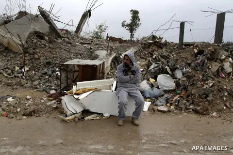 A Palestinian man, stands on next to the rubbles of his house, which was destroyed by Israeli shelling during a 50- day-war last summer, on a stormy day in the east of Khan Younis in the southern Gaza Strip January 8, 20...