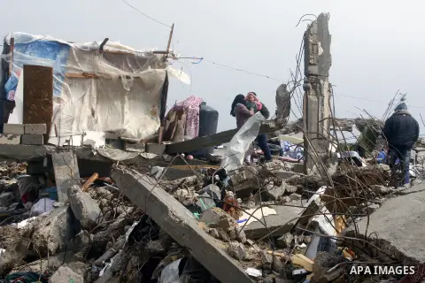 A Palestinian woman, stands on the rubbles of her house, which was destroyed by Israeli shelling during a 50- day-war last summer, on a stormy day in the east of Khan Younis in the southern Gaza Strip January 8, 2015. He...