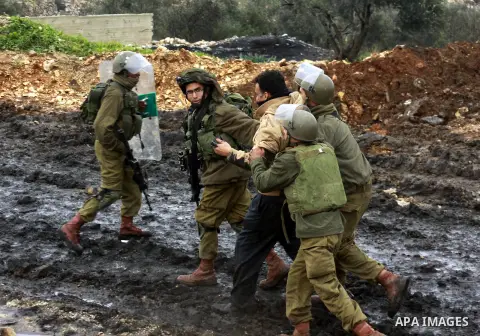 Israeli security forces detain a Palestinian protester during clashes following a protest against the expropriation of Palestinian land by Israel in the village of Kafr Qaddum, near the West Bank city of Nablus, January...