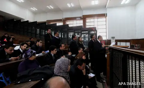 Relatives and friends attend the retrial of Alaa Abdel Fattah and 24 others, in the courtroom in Cairo on January 17, 2015. The defendants were sentenced in June to 15 years in prison for holding an unlicensed and violen...