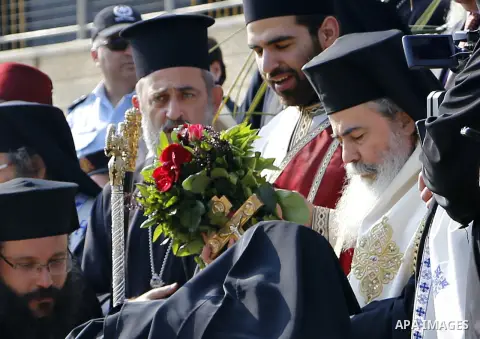 Greek Orthodox Patriarch of Jerusalem Theophilos III attends a ceremony at the baptismal site known as Qasr el-Yahud on the banks of the Jordan River near the West Bank city of Jericho January 18, 2015. Orthodox Christia...