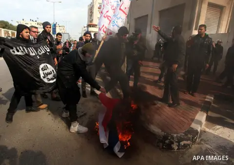 Palestinian Salafists burn French flag during in a protest against satirical French weekly magazine Charlie Hebdo's cartoons of the Prophet Mohammad, outside the French Cultural Centre in Gaza city January 19, 2015. Doze...