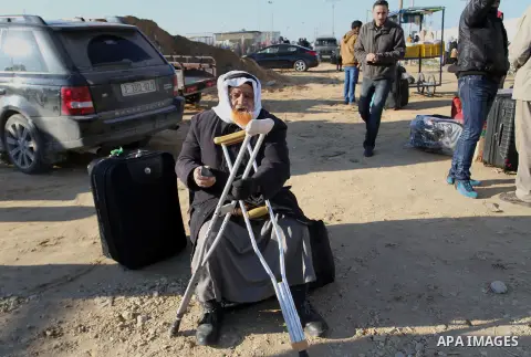 Palestinians, hoping to cross into Egypt , as they wait at the Rafah crossing between Egypt and the southern Gaza Strip January 20, 2015. Egyptian authorities opened Rafah crossing, Gaza's main window to the outside worl...